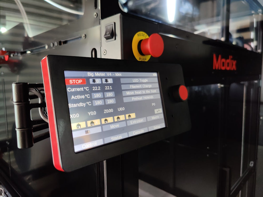 Tilting touch screen, two emergency stop buttons and a frontal power switch button.